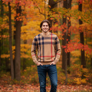 Plaid sweater with beige, red, and navy pattern on a gray background