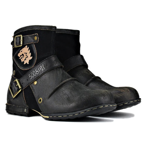 Pair of black leather boots with gold buckles and stitching on a white background