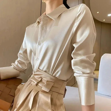 Champagne satin button-down shirt worn by a model with a beige skirt.