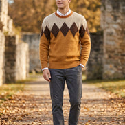 A men's long-sleeve knit sweater with a classic argyle pattern in shades of brown, beige, and camel orange, 
