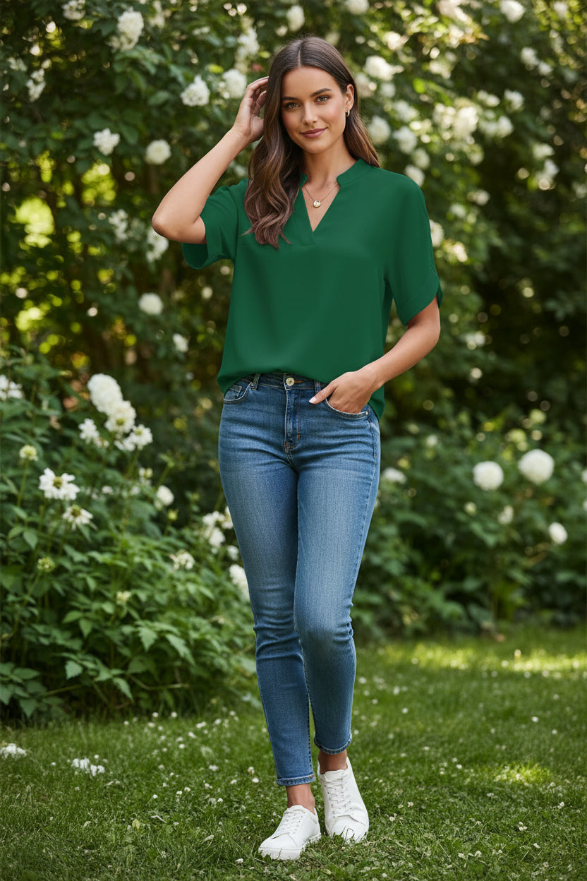 Green blouse worn by a person with a neutral background