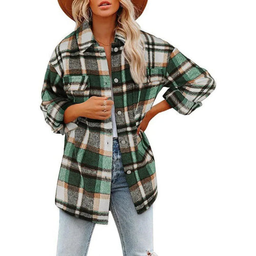 Woman wearing a green and cream plaid shirt with a white top and jeans, against a white background.