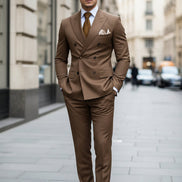 Brown suit with a tie and pocket square on a dark background