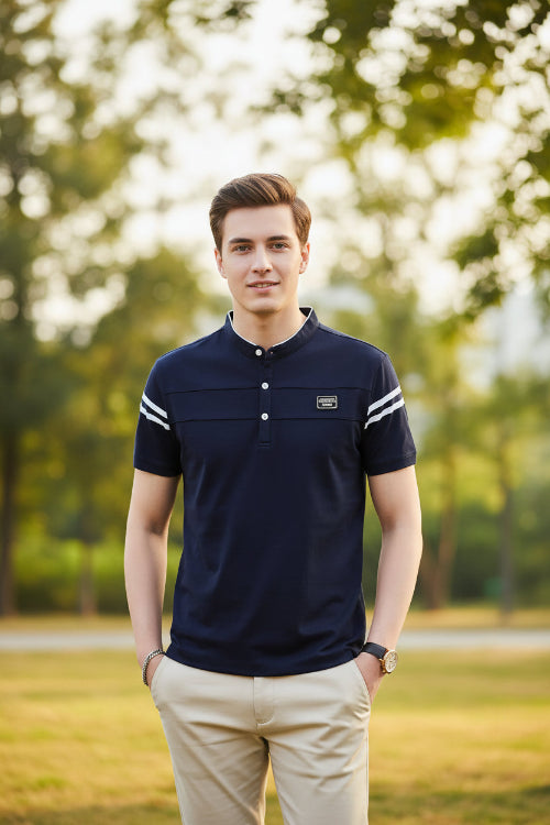 Man wearing a navy blue polo shirt with white stripes on a dark background