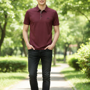 Maroon polo shirt worn by a person on a gray background