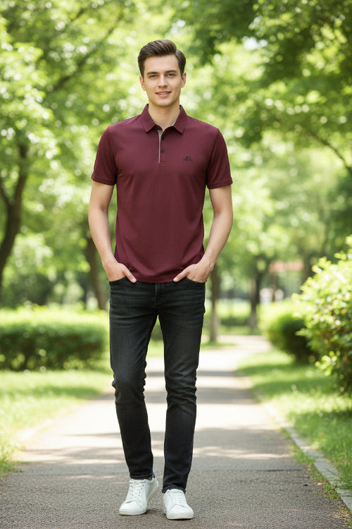 Maroon polo shirt worn by a person on a gray background
