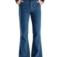 A person wearing blue flared pants with a black belt and black shoes, shown from the waist down against a plain white background.