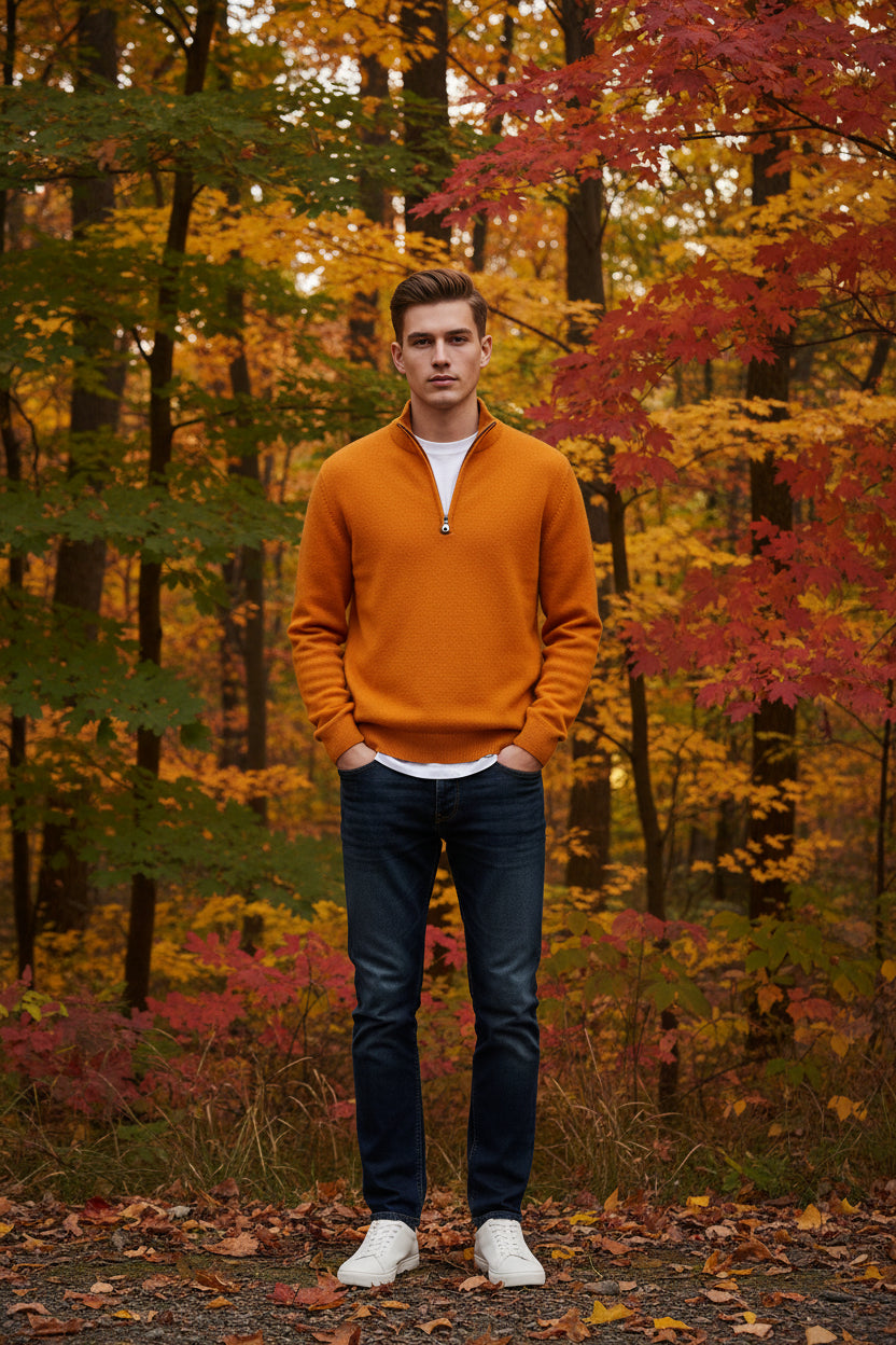 Orange fleece pullover and watch on a gray surface