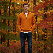 Orange fleece pullover and watch on a gray surface