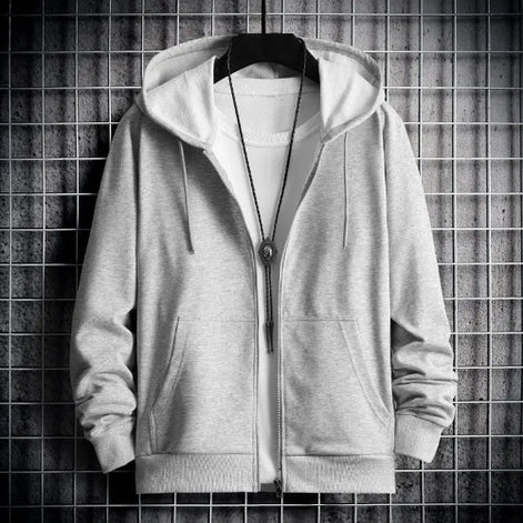 Gray hoodie with a zipper on a hanger against a tiled wall background