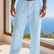 Person wearing light blue pants with a blurred scenic background