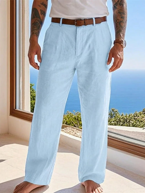 Person wearing light blue pants with a blurred scenic background