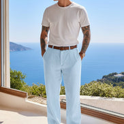 Person wearing light blue pants with a blurred scenic background