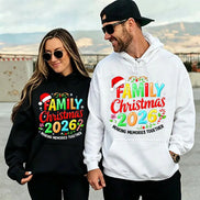 A man and a woman wearing matching holiday-themed hoodies with colorful 'Family Christmas 2026' graphics.