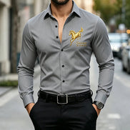 A man wearing a fitted long-sleeve gray dress shirt with a gold embroidered horse logo and the words 'Success at first fly' on the left chest, 