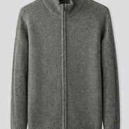 A gray knit zip-up sweater with a mock neck and ribbed cuffs and hem, hanging on a wooden hanger against a light gray background. 