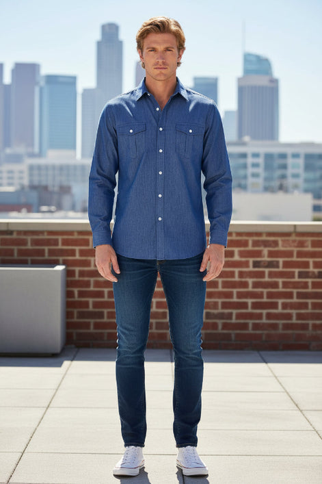 Man wearing a blue denim shirt with a city skyline in the background
