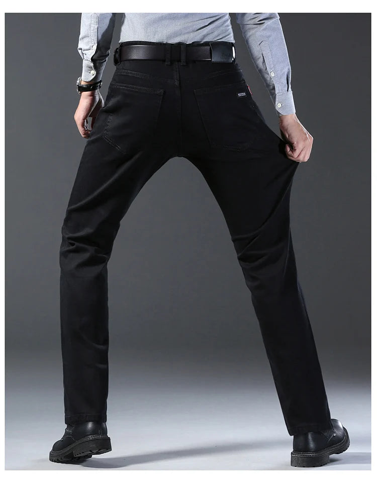 Person wearing black pants on a gray background
