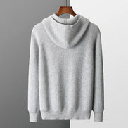 Gray hoodie on a hanger against a gray background