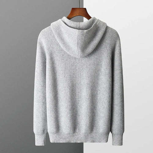 Gray hoodie on a hanger against a gray background
