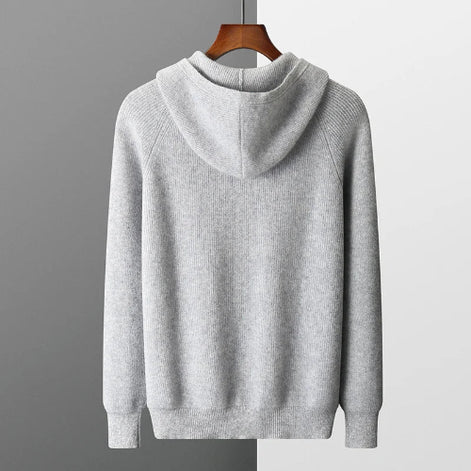 Gray hoodie on a hanger against a gray background