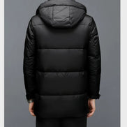 Black puffer jacket with a hood on a gray background