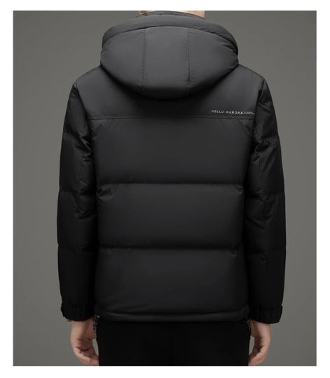 A person shown from the back wearing a black hooded puffer jacket with horizontal quilting and a small white 'HELLO WORLD' text print on the upper back, against a plain gray studio background.