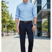 Person wearing dark gray pants with a brown belt and shoes on a light gray background