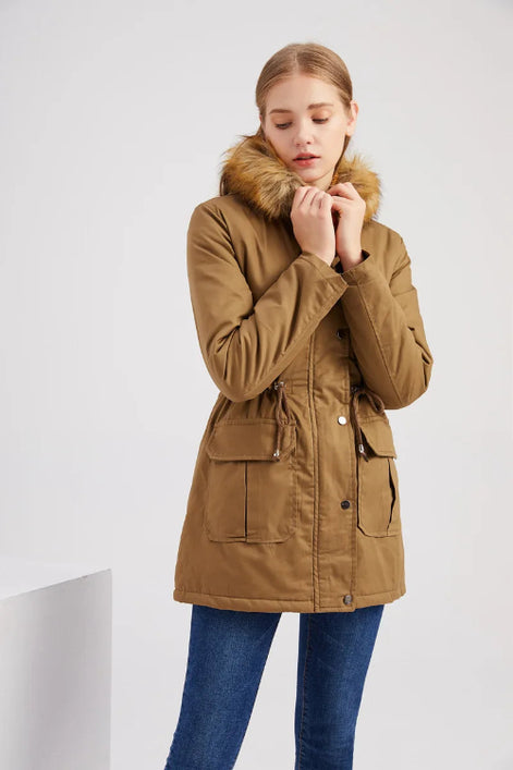 Woman wearing a brown parka with fur hood on a white background