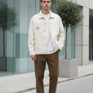 Beige denim jacket worn by a person on a white background