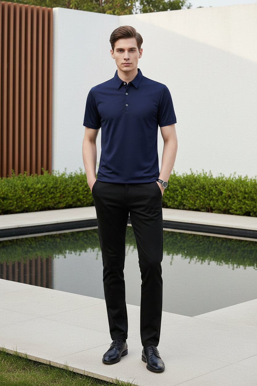 Navy blue polo shirt worn by a person on a gray background