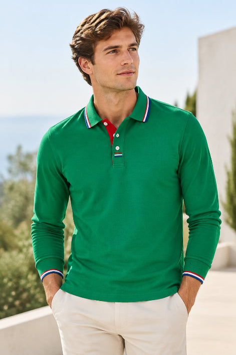 A long-sleeve green polo shirt with a classic collar, featuring a red inner placket and white, red, and blue striped trim on the collar and cuffs, 