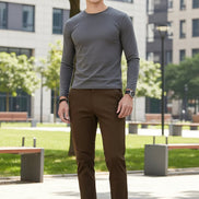 Brown pants worn by a person on a gray background