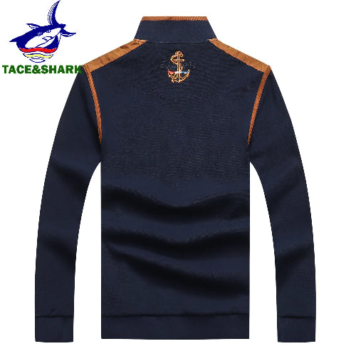 A navy blue long-sleeve half-zip sweatshirt with tan shoulder panels and a gold anchor emblem on the upper back, 
