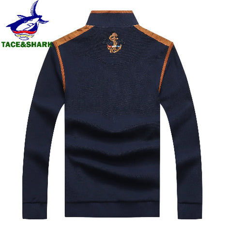A navy blue long-sleeve half-zip sweatshirt with tan shoulder panels and a gold anchor emblem on the upper back, 