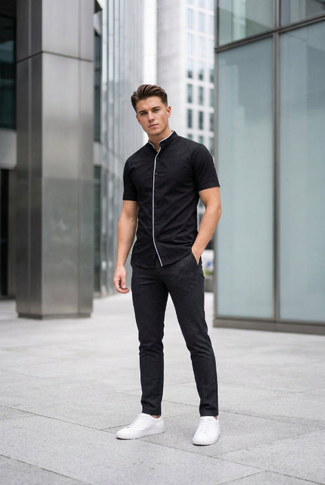 A black short-sleeve button-up shirt with a mandarin collar and white piping trim, shown on a plain white background.