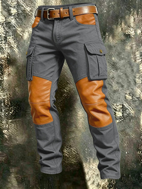 Gray cargo pants with tan contrast panels at the knees and front pockets, flap thigh pockets, and a brown belt against a textured gray background.