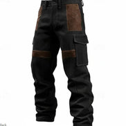 Black corduroy cargo pants with brown contrast panels, belt loops, and flap thigh pockets against a white background.⠋