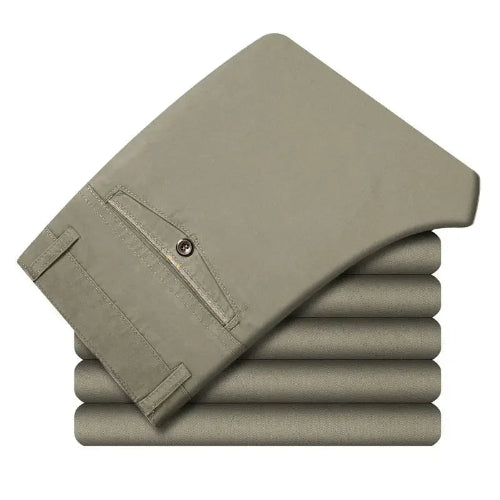 Stack of beige pants on a white background
