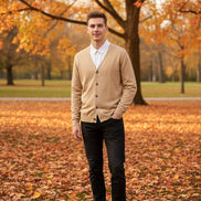 Beige cardigan over a white shirt on a wooden hanger