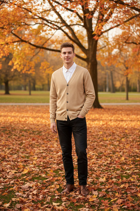 Beige cardigan over a white shirt on a wooden hanger