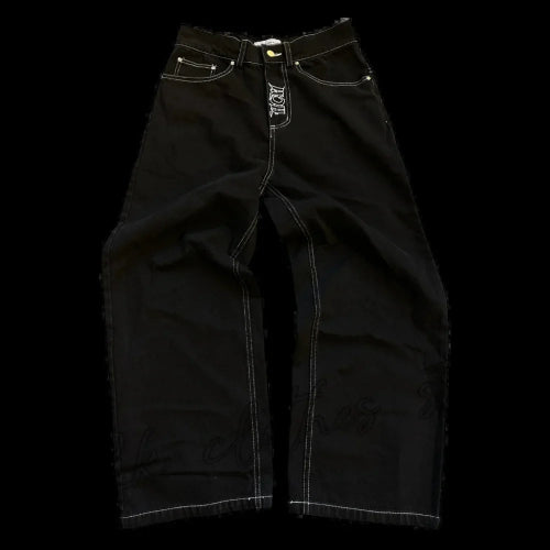 Front view of black wide-leg jeans laid flat, showing white contrast stitching, front pockets, belt loops, and a small white graphic on the fly.
