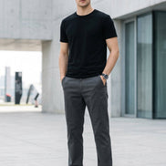 A person wearing straight-leg gray trousers, paired with a black t-shirt and white sneakers, 