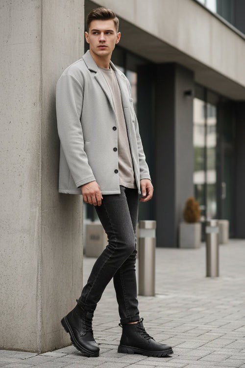 Black leather boots on a brown surface with a neutral background
