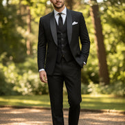 Black tuxedo with white shirt and black tie on a light gray background