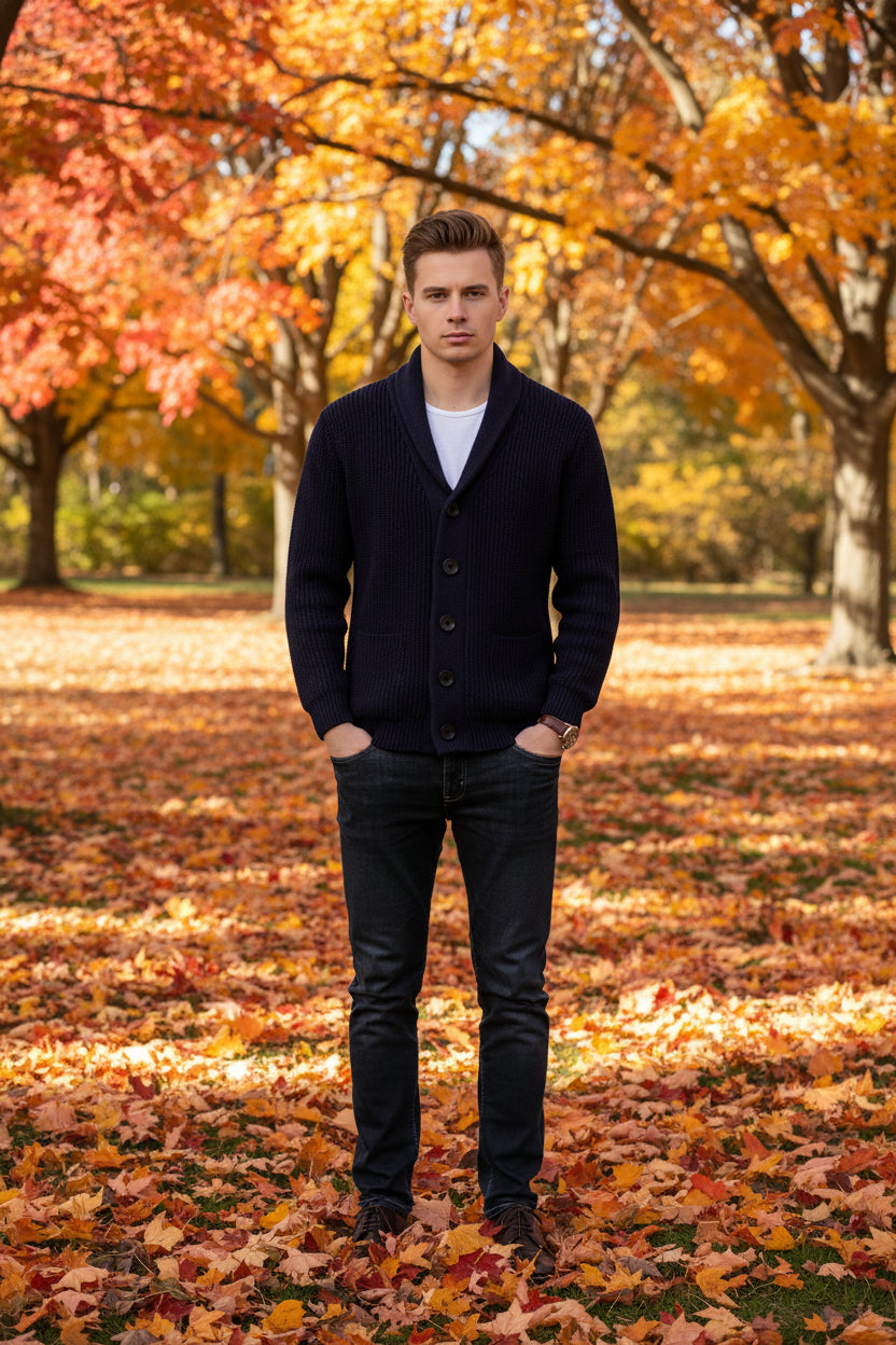Navy blue cardigan worn by a person on a gray background