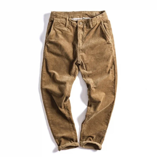 A pair of brown corduroy pants laid flat on a white background, featuring a relaxed fit and cuffed ankles.