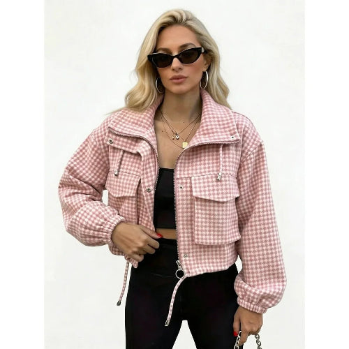 Woman wearing a pink and cream checked utility jacket with chest flap pockets, a ring-pull zipper and drawcord hem over a black top and trousers