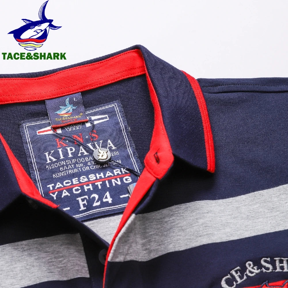 Close-up of a striped polo shirt collar and inner neck label. The shirt is navy blue with a wide gray stripe and red trim along the collar and placket.