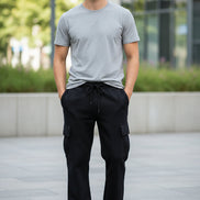Person wearing black pants and a gray shirt on a white background